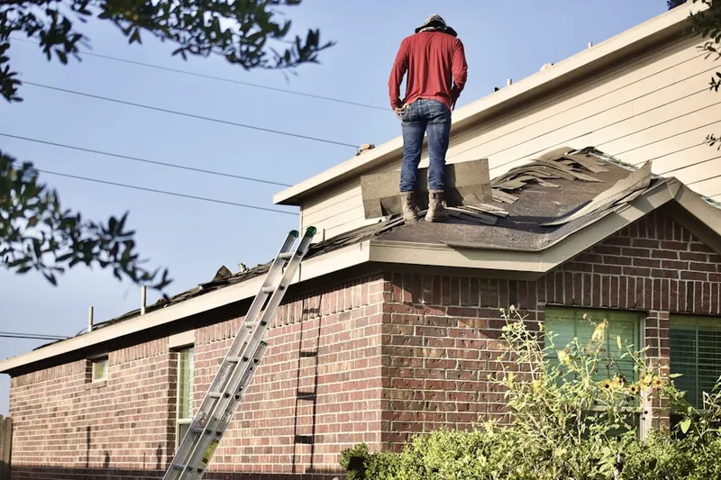 Professional roofer working on a residential roof in Wequetequock